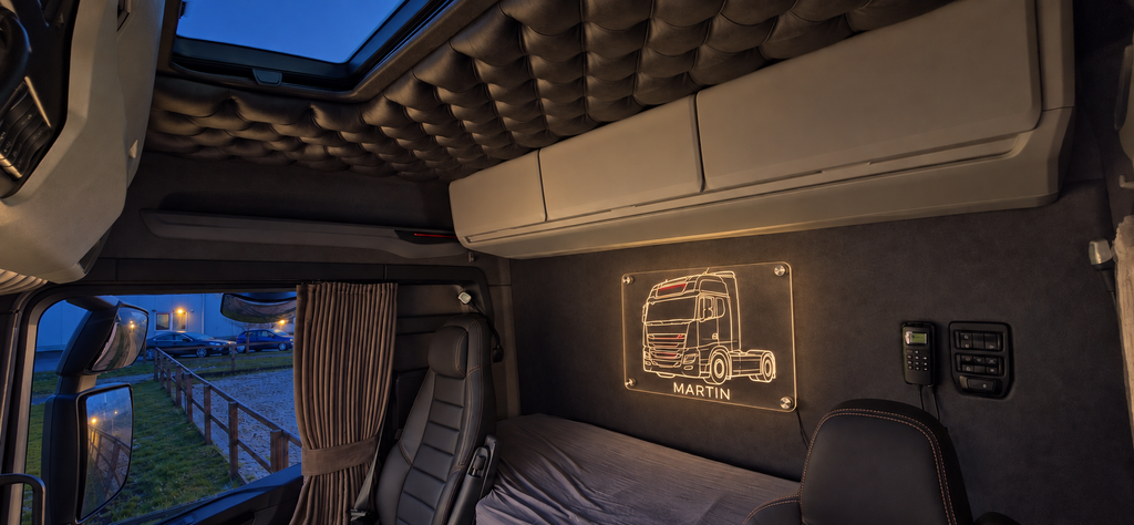 Illustrative personalised truck LED sign displayed inside a truck cabin at night.